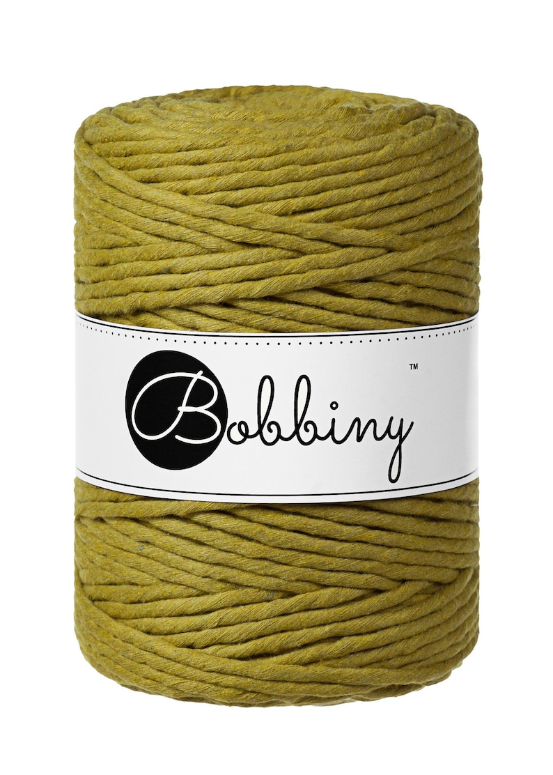 May include: A spool of mustard yellow cotton cord, wrapped in a white label with the text "Bobbiny&trade;".