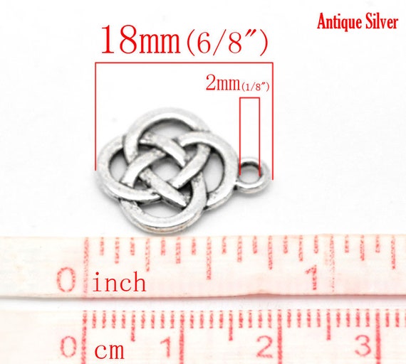 4 Celtic knot charms silver tone R156