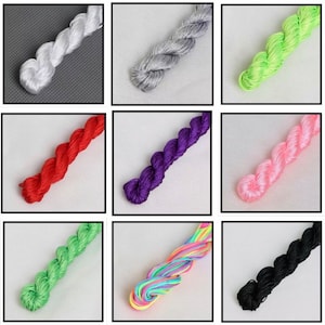 May include: Nine skeins of embroidery floss in various colors. The colors include white, silver, lime green, red, purple, pink, light green, a rainbow mix, and black. Each skein is tightly twisted and displayed against a white or gray background.