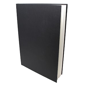 May include: A black hardback sketchbook with a textured cover. The book is closed and standing upright against a white background.
