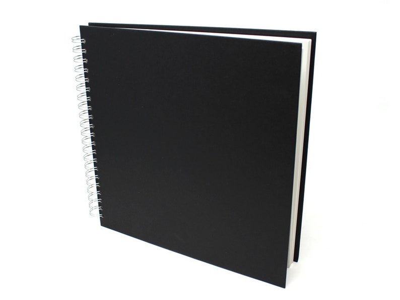 May include: A black spiral bound sketchbook with a black cover.