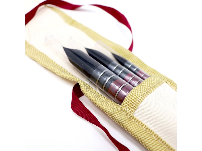 May include: A set of three black and red calligraphy brushes in a beige canvas case with a red ribbon.