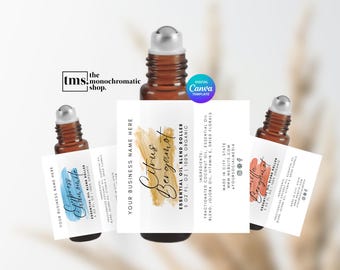 Puede incluir: Botellas de rodillo de aceite esencial de vidrio ámbar con etiquetas. Las etiquetas presentan el texto "Citrus Bergamot", "Cypress & Chamomile" y "Vanilla Bergamot". Las etiquetas también incluyen el texto "Essential Oil Blend Roller" y "100% Organic".