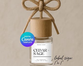 May include: A clear glass bottle with a wooden cap and a white label that reads "CEDAR + SAGE OIL DIFFUSER 0.33 FL. OZ (30 ML)". The bottle is hanging from a brown rope with a bow. The label size is 1" x 1".