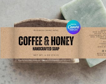 May include: A brown paper label with the text "BUSINESS NAME HERE", "COFFEE & HONEY", "HANDCRAFTED SOAP", and "NET WT. 4 OZ (113 G)". The label is on top of a brown and beige bar of soap. The soap is next to a light green bar of soap.