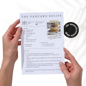 May include: A printable recipe card for making pancakes. The card has a black and white design with a photo of a stack of pancakes with blueberries and maple syrup. The recipe includes ingredients like all-purpose flour, sugar, baking powder, salt, milk, eggs, melted butter, vanilla extract, and powdered sugar. The instructions are to whisk the dry ingredients together, then whisk the wet ingredients together, and then combine the two mixtures. The recipe also includes optional ingredients like chocolate chips, nuts, and fruit.