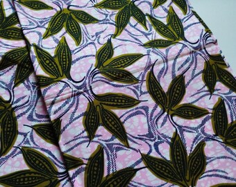 May include: Pink fabric with a repeating pattern of large, stylized leaves in olive green and black. The leaves are set against a background of white and blue wavy lines, creating a vibrant textile design.