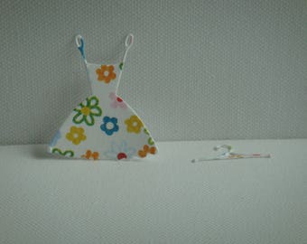 Cut paper design ornate with its little dress hanger for creation
