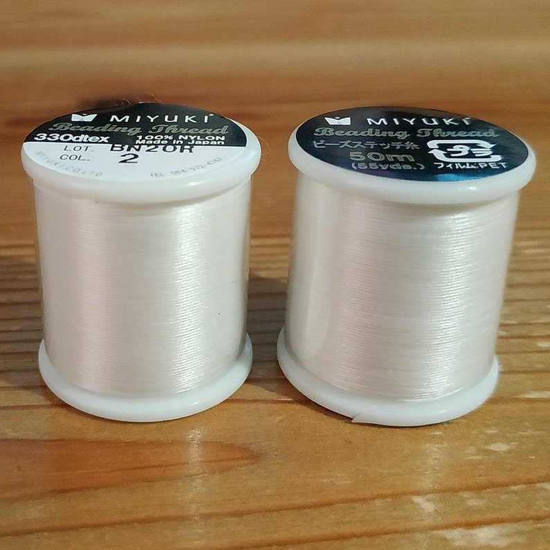 A spool of Miyuki nylon thread Ivoire