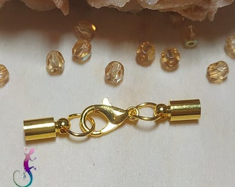 Complete clasp in gold metal with glue-on tips