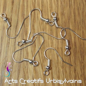 May include: Five silver earring hooks with a small ball at the end of each hook. The hooks are made of metal and have a spring-loaded closure.