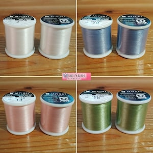 May include: Eight spools of white, blue, pink, and green beading thread. Each spool is labelled "MIYUKI Beading Thread" and has a different colour and lot number.