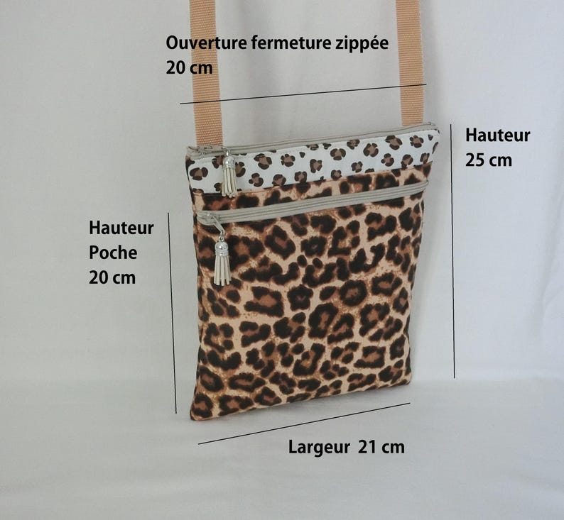 May include: A rectangular crossbody bag with a leopard print pattern. The bag has a beige strap and two zippered compartments. The bag's height is 9.8 inches, the pocket height is 7.9 inches, and the width is 8.3 inches. The zipper opening is 7.9 inches.