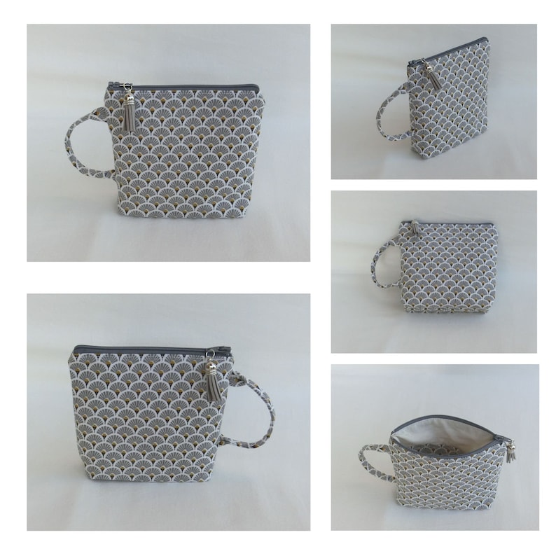 May include: A gray and white zippered pouch with a gold and white geometric pattern. The pouch has a gray tassel and a gray loop handle.