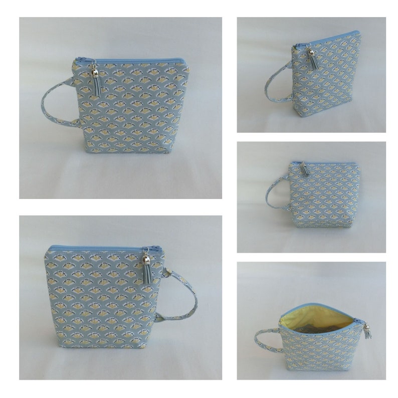 May include: A light blue zippered pouch with a small tassel and a handle. The pouch has a white and light blue patterned design.