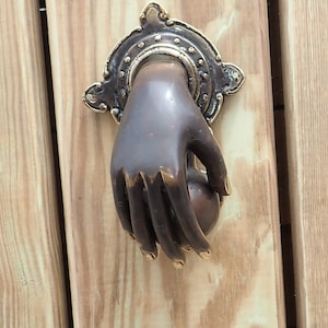 Brass hand entry door knocker for exterior door