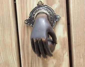 Brass hand entry door knocker for exterior door