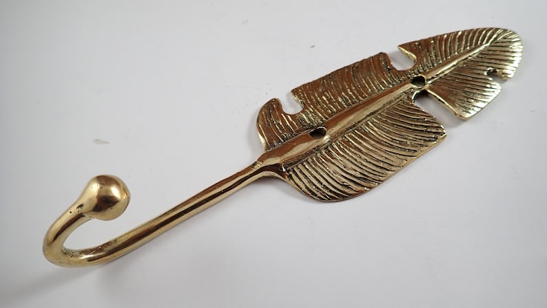 Side angle close up of brass leaf hook showing the curved neck and ball tip hook against a grey background
