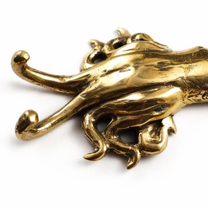 Close up of brass squid tentacle wall hook detailed ocean sea creature decor