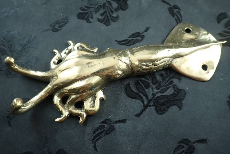 Side view brass squid wall hook showing curved tentacle hook function