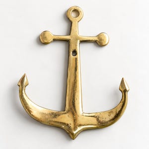 Brass anchor wall hook in a polished brass finish on a white background, nautical coat hook and maritime wall decor