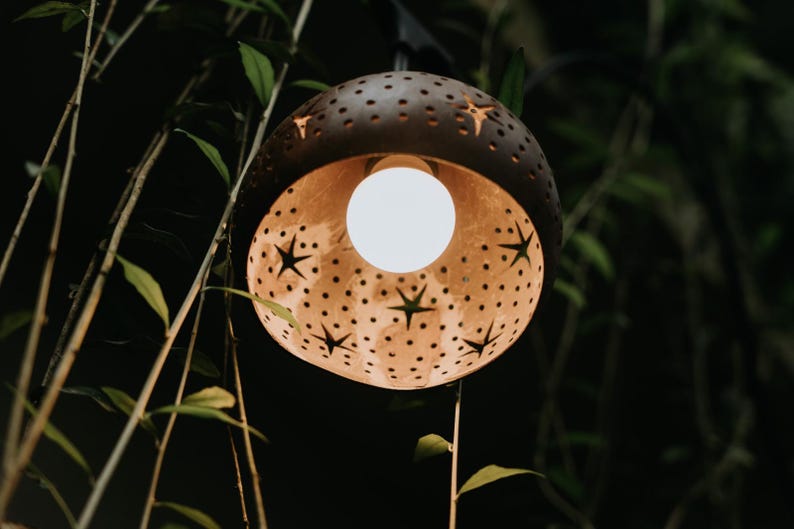 Carved coconut lamp glowing warm light, handmade coconut shell pendant lamp decor