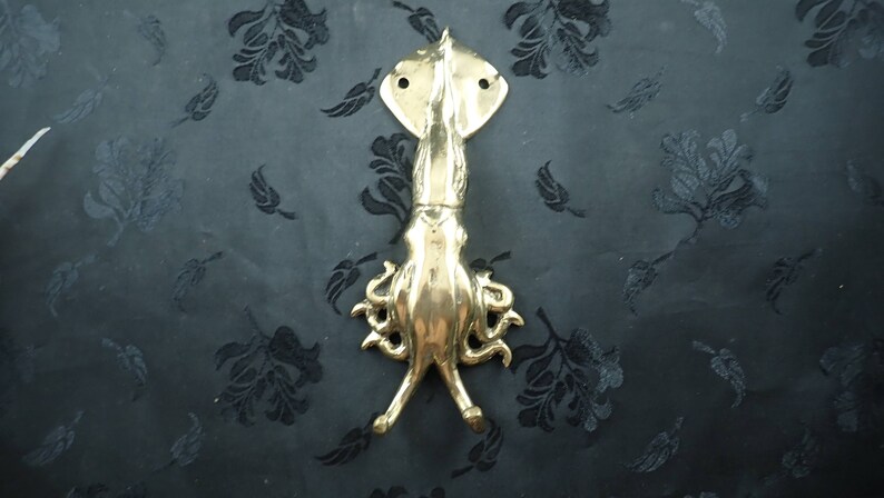 Squid wall hook displayed on dark background highlighting shape and tentacle design