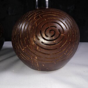 Carved coconut shell lamp pattern detail, handmade coconut lighting design Bali