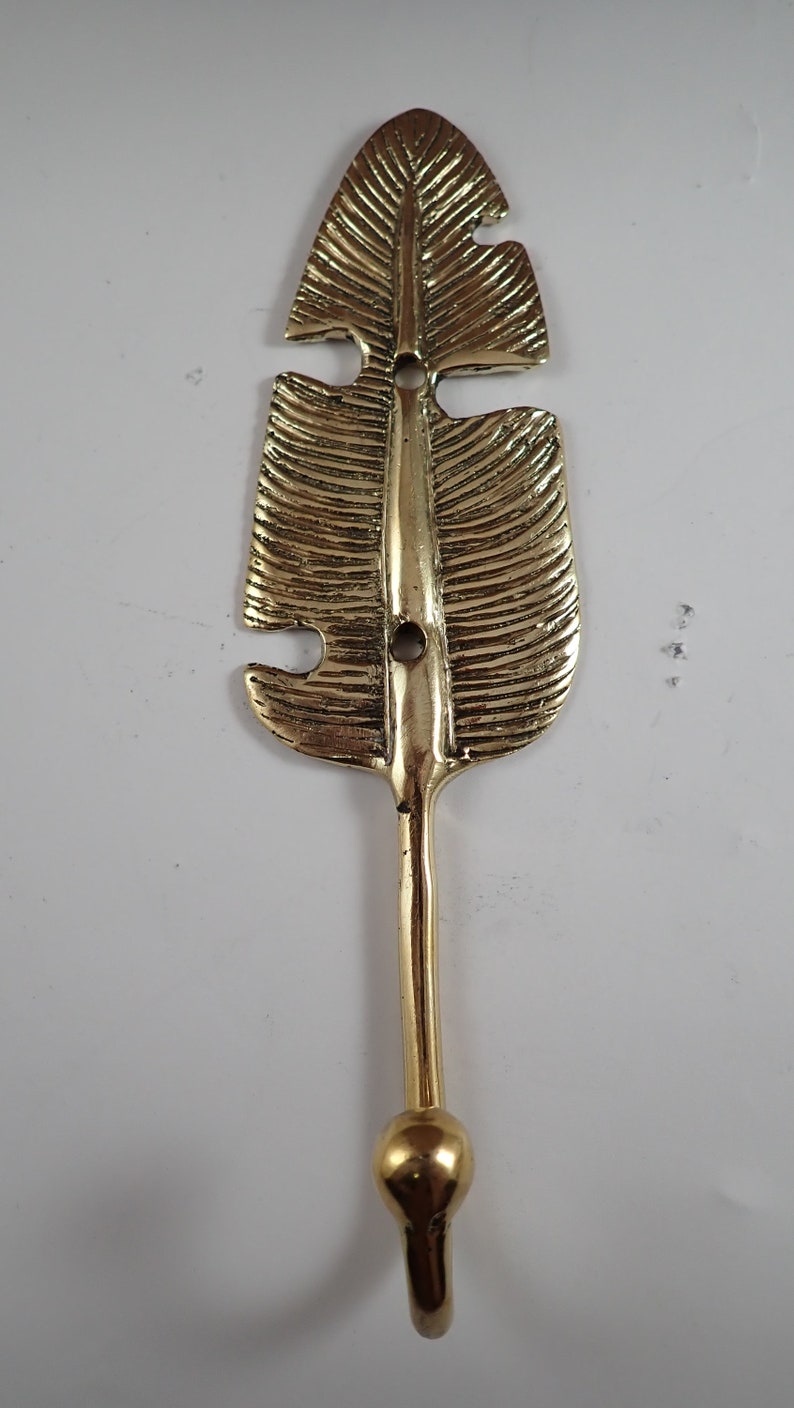 Close up of the brass ball tip hook end on a banana leaf wall hook, top angle detail shot