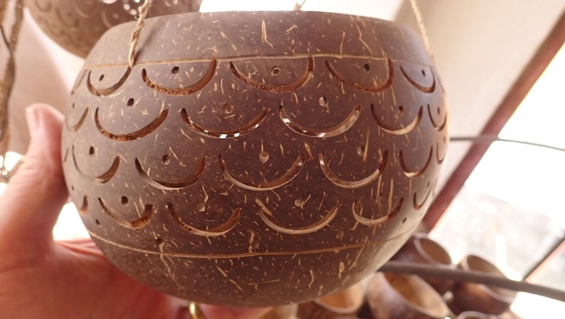 Handmade coconut shell pendant lamp carving detail, tropical lighting craftsmanship