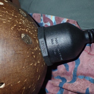 Coconut shell lamp cord connection detail, tropical handmade lighting component