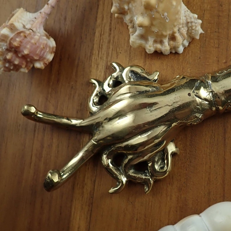 Brass squid wall hook styled with seashells beach house coastal decor ocean theme