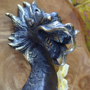 Dragon head close up vintage brass dragon door handle detail