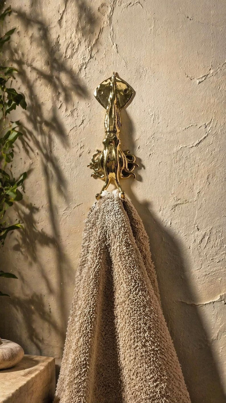 Squid wall hook used as towel hanger in coastal bathroom decor, nautical sea life wall hook styling