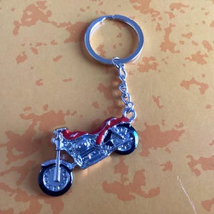Silver metal key ring with red motorcycle