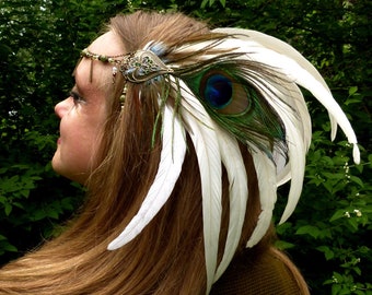 Tiare Guardian with long white feathers and peacock feather and pearls jade green accessories hairstyle pagan ritual tribal fusion