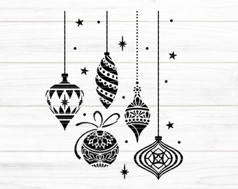 May include: Five black and white Christmas ornaments with intricate designs hanging from strings against a white woodgrain background.