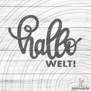 May include: A dark gray script graphic featuring the word "hallo" in a cursive font with the word "WELT!" in a bold sans-serif font below it. The design is overlaid on a background of concentric black and red circular lines.