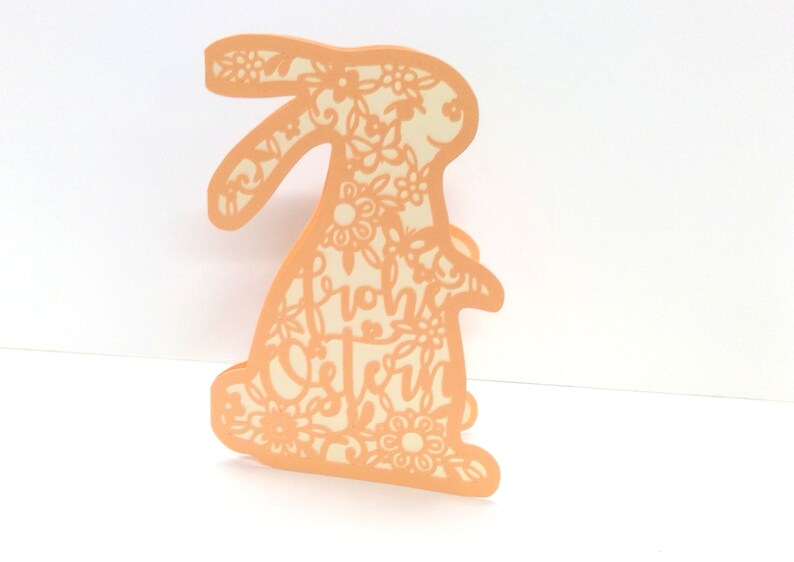 May include: A peach-colored paper cutout of a bunny with floral designs and the text "from the Stern" inside the cutout.