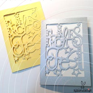 May include: Two rectangular greeting cards with intricate laser-cut designs. One card is matte yellow, and the other is shimmering silver. Both feature the German text "Frohes Fest" integrated with star and Christmas tree cutouts.