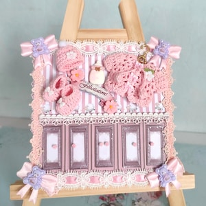 1 Exceptional G/ Luxury Baby Girl card (decorated interior with card effects) Rare item with mini knitted layettes in a shop window setting
