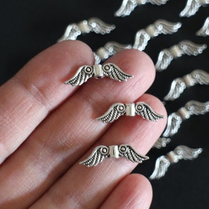 10 silver metal wing beads 23 x 7 mm