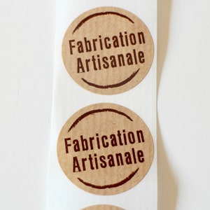 May include: Two brown paper stickers with the text "Fabrication Artisanale" printed in brown ink.