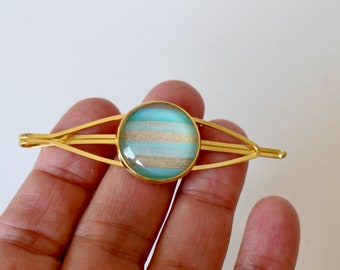 A diamond-shaped barrette clip with blue cabochon and golden brass Handmade many other models in other ads