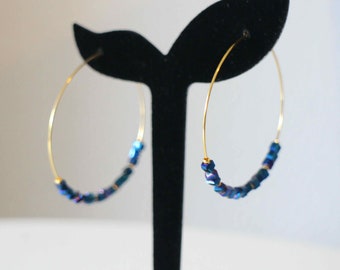 Gold stainless steel hoop earrings with faceted midnight blue square beads Handmade in free gift packaging