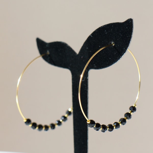 Gold stainless steel hoop earrings and round faceted black glass beads Handmade gift bag in white organdy offered