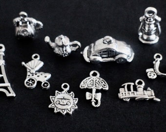 10 different vintage retro themed charms in silver brass telephone cradle Eiffel Tower sun car scooter