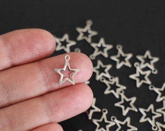 10 hollowed out star charms in silver stainless steel 15 x 13 mm