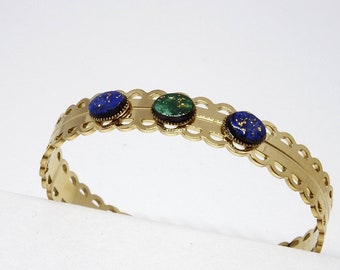 Lace bangle in steel and mahogany wood stone hand painted in green, blue and gold leaf.