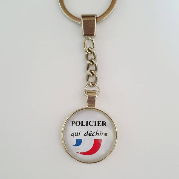 Porte clé  policier qui déchire à cabochon 25mm